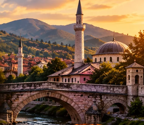 Old stone bridge, minarets and hills at sunset